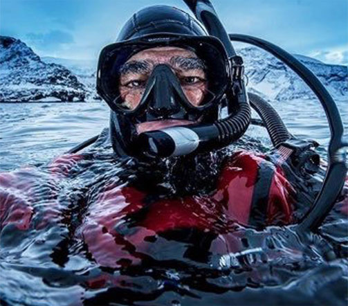Amos Nachoum on the surface of the water in scuba gear