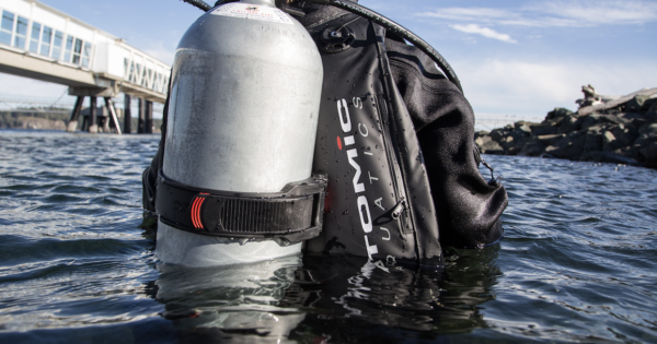 Scuba diver at surface wearing an Atomic Aquatics BCD